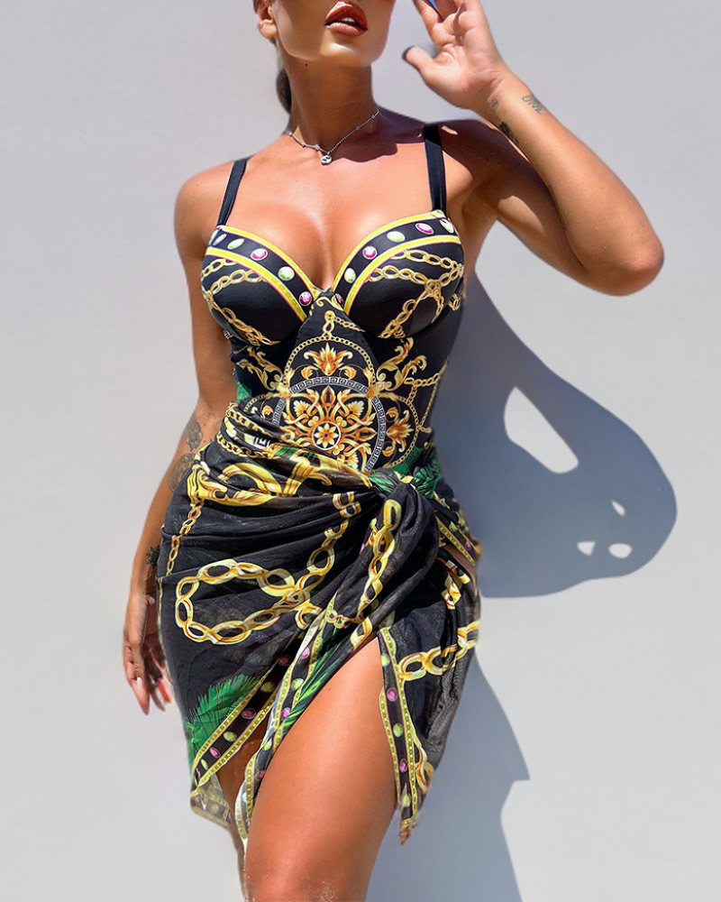 Aitana - maillot une pièce noir à motifs dorés et verts avec paréo noué, vue de face